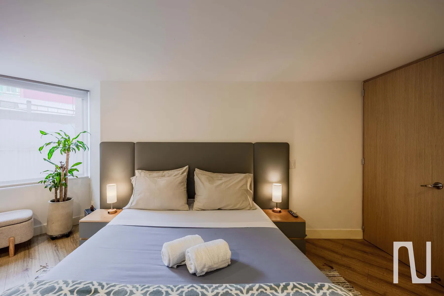 Bedroom 1 with double bed and bedside lamps